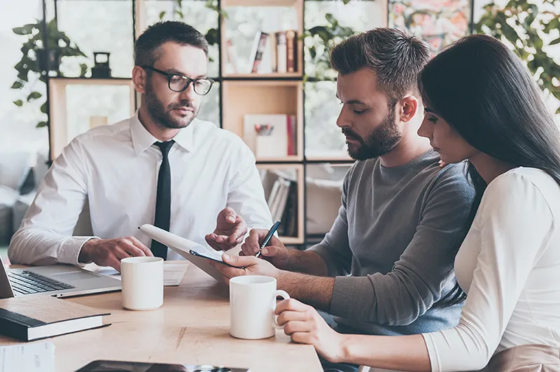 An adviser talking a couple through their finance options